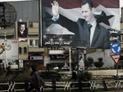 A Syrian woman walks past a poster for President Bashar Assad in an Alawite-dominated neighborhood in the western city of Homs, on Jan. 11, 2012. Support among the president's own minority sect is waning. A Syrian woman walks past a poster for President Bashar Assad in an Alawite-dominated neighborhood in the western city of Homs, on Jan. 11, 2012. Support among the president's own minority sect is waning.