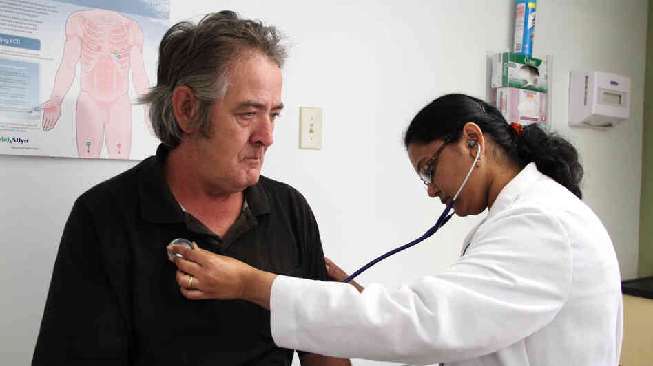 Dr. Madhumathi Gunasekaran examines John Pike at the Northgate II clinic in Camden, N.J. Dr. Madhumathi Gunasekaran examines John Pike at the Northgate II clinic in Camden, N.J.