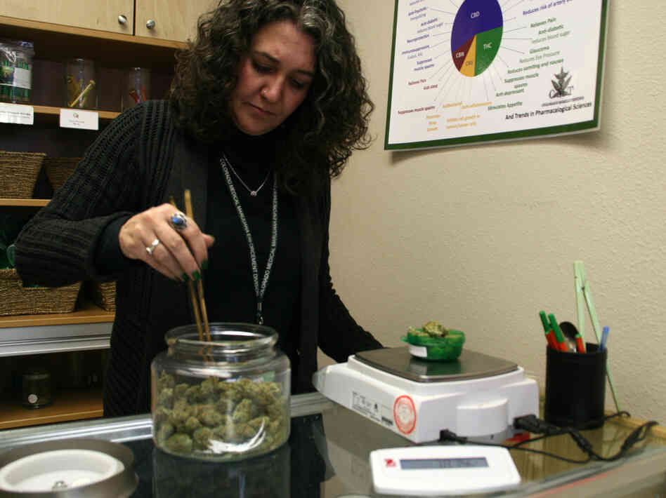 Erica Freeman of Choice Organics weighs medical marijuana for a customer. Erica Freeman of Choice Organics weighs medical marijuana for a customer.