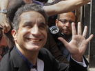 Popular satirist Bassem Youssef, who has come to be known as Egypt's Jon Stewart, waves as he enters Egypt's state prosecutors office on Sunday. Popular satirist Bassem Youssef, who has come to be known as Egypt's Jon Stewart, waves as he enters Egypt's state prosecutors office on Sunday.