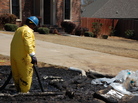 A worker cleans up oil in Mayflower, Ark., on Monday, days after a pipeline ruptured and spewed oil over lawns and roadways. A worker cleans up oil in Mayflower, Ark., on Monday, days after a pipeline ruptured and spewed oil over lawns and roadways.