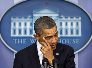President Obama wipes away tears as he talks about the Connecticut elementary school shooting on Dec. 14, 2012, in the White House briefing room. Obama was in Colorado on Wednesday and planned to visit Connecticut next week to keep pushing for new gun laws.