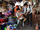 Deuk Chamnan (right), a credit officer at First Finance, speaks with a potential client while passing out leaflets at Century Market in Phnom Penh. First Finance also advertises on the radio. Deuk Chamnan (right), a credit officer at First Finance, speaks with a potential client while passing out leaflets at Century Market in Phnom Penh. First Finance also advertises on the radio.