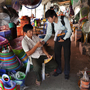 Deuk Chamnan (right), a credit officer at First Finance, speaks with a potential client while passing out leaflets at Century Market in Phnom Penh. First Finance also advertises on the radio. Deuk Chamnan (right), a credit officer at First Finance, speaks with a potential client while passing out leaflets at Century Market in Phnom Penh. First Finance also advertises on the radio.