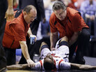 Trainers check on Louisville guard Kevin Ware after he injured his lower right leg during the Midwest Regional final against Duke in the NCAA college basketball tournament. Trainers check on Louisville guard Kevin Ware after he injured his lower right leg during the Midwest Regional final against Duke in the NCAA college basketball tournament.