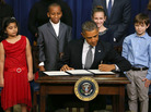 President Obama signs a series of executive orders on gun control Jan. 16 surrounded by children who wrote letters to the White House about gun violence. They are, from left, Hinna Zeejah, Taejah Goode, Julia Stokes and Grant Fritz. President Obama signs a series of executive orders on gun control Jan. 16 surrounded by children who wrote letters to the White House about gun violence. They are, from left, Hinna Zeejah, Taejah Goode, Julia Stokes and Grant Fritz.