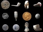Found objects from the Thames. Top row: a 1687 tin halfpenny, a Victorian clay pipe, a gold ring, a Victorian ring. Middle row: a decorated medieval button, a Victorian clay pipe, an 1830 George IV farthing, a Georgian military button. Bottom row: a Hooper Brewery stopper, a sailor's bag lock, a French Jacob pipe bowl and a child's toy clay pipe bowl. Note: objects not to scale. Found objects from the Thames. Top row: a 1687 tin halfpenny, a Victorian clay pipe, a gold ring, a Victorian ring. Middle row: a decorated medieval button, a Victorian clay pipe, an 1830 George IV farthing, a Georgian military button. Bottom row: a Hooper Brewery stopper, a sailor's bag lock, a French Jacob pipe bowl and a child's toy clay pipe bowl. Note: objects not to scale.