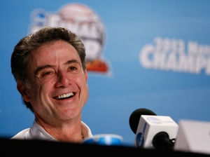 Head coach Rick Pitino of the Louisville Cardinals smiles as he answers questions from the media at his post game news conference. Pitino became the first coach to win national titles at two schools.