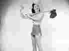 Woman hitchhiking with a bindle.