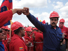Venezuela's acting president, Nicolas Maduro, fist-bumps a worker of the state-run oil company, Petroleos de Venezuela, S.A., last month. Maduro faces opposition candidate Henrique Capriles in Sunday's presidential election. Whoever wins will have to tackle the legacy of Chavez's oil programs. Venezuela's acting president, Nicolas Maduro, fist-bumps a worker of the state-run oil company, Petroleos de Venezuela, S.A., last month. Maduro faces opposition candidate Henrique Capriles in Sunday's presidential election. Whoever wins will have to tackle the legacy of Chavez's oil programs.