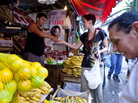 Tatiana Coelho buys fruit from a vendor in a favela in Rio de Janeiro, Brazil, on Sept. 20, 2012. Prices, especially for food, are skyrocketing in Brazil. Tatiana Coelho buys fruit from a vendor in a favela in Rio de Janeiro, Brazil, on Sept. 20, 2012. Prices, especially for food, are skyrocketing in Brazil.