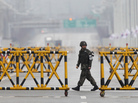 A South Korean soldier patrols as vehicles returning from the jointly run Kaesong industrial complex in North Korea arrive at a checkpoint in Paju, north of Seoul, on April 6. A South Korean soldier patrols as vehicles returning from the jointly run Kaesong industrial complex in North Korea arrive at a checkpoint in Paju, north of Seoul, on April 6.