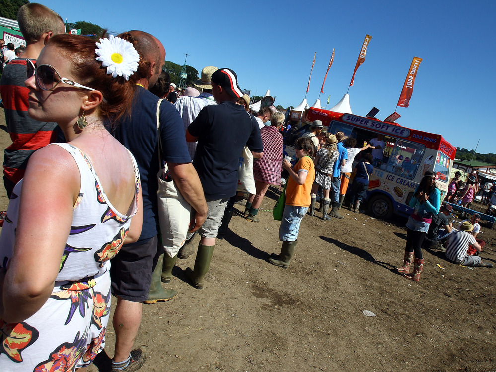 Customers line up for an ice cream van at the 2011 Glastonbury Music Festival in southwest England.