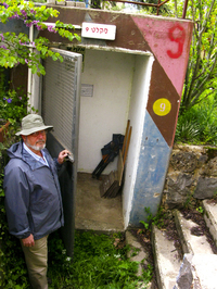 Nadav Katz shows the entrance to a bomb shelter on the kibbutz where he lives in the Israeli-occupied Golan Heights. The war in Syria has kibbutz members double-checking to make sure the shelters are ready to go.