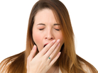 A young woman yawns. A young woman yawns.