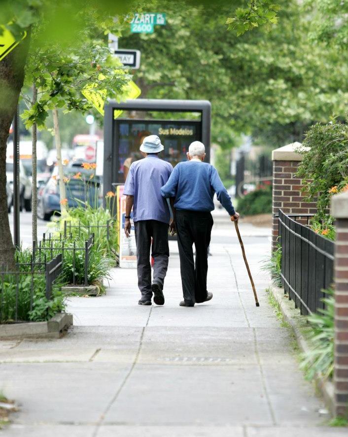 Cosby walks with a friend in the Adams Morgan neighborhood of Washington, D.C., in this undated photograph. (Image credit: Courtesy of Church of the Saviour)