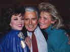 Joan Collins, John Forsythe and Linda Evans at a party celebrating the production of 150 episodes of Dynasty in 1986.