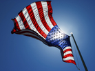 An American flag waves in the sky. An American flag waves in the sky.
