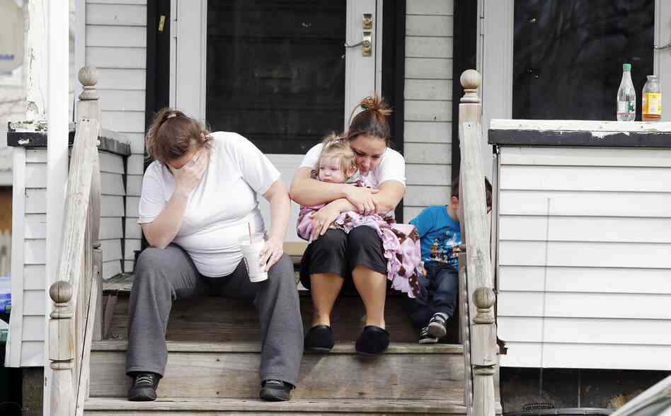Neighbors sit outside the house of Krystle Campbell's parents in Medford, Mass., on Tuesday. Campbell was killed in the explosions at the finish line of the Boston Marathon on Monday. Neighbors sit outside the house of Krystle Campbell's parents in Medford, Mass., on Tuesday. Campbell was killed in the explosions at the finish line of the Boston Marathon on Monday.