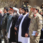 Afghan and U.S. officials attend the closing ceremony for the Paktia provincial reconstruction team on April 9 in eastern Afghanistan. NATO created more than 20 teams to help the Afghans rebuild. But now the U.S. teams are winding down their activities.