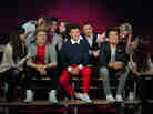 Fans pose for pictures with waxwork models of English-Irish boy band 'One Direction' at Madame Tussauds in London this week.