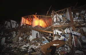 A fire still burns in a apartment complex destroyed near the plant.