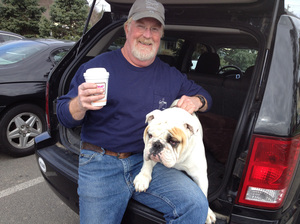Mike Cragin and his bulldog, Truman, stopped by the Dunkin' Donuts in Newtown, Conn., on Thursday. After the elementary school shooting in December, Cragin came to the same place and put up a sign inviting people to hug his dog. Mike Cragin and his bulldog, Truman, stopped by the Dunkin' Donuts in Newtown, Conn., on Thursday. After the elementary school shooting in December, Cragin came to the same place and put up a sign inviting people to hug his dog.