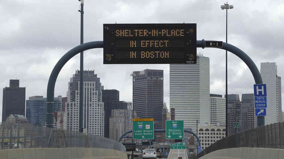 A sign calling for citizens of Boston to "Shelter in Place" hung across I-93 Friday in Boston. A sign calling for citizens of Boston to "Shelter in Place" hung across I-93 Friday in Boston.