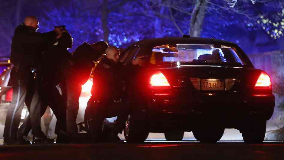 Police with guns drawn search for one of the Boston Marathon suspects early Friday in Watertown, Mass. Police with guns drawn search for one of the Boston Marathon suspects early Friday in Watertown, Mass.