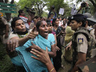 Activists from India's main opposition party jostle with police outside Sonia Gandhi's residence on Sunday. Activists from India's main opposition party jostle with police outside Sonia Gandhi's residence on Sunday.