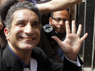 Egyptian satirist Bassem Youssef waves to his supporters as he enters Egypt's state prosecutor general's office in Cairo on March 31 to face charges of allegedly insulting Islam and the country's leader. Egyptian satirist Bassem Youssef waves to his supporters as he enters Egypt's state prosecutor general's office in Cairo on March 31 to face charges of allegedly insulting Islam and the country's leader.