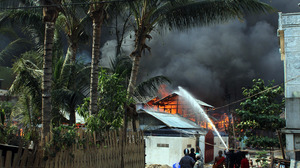 Firefighters try to extinguish a fire during the riots in Meiktila in March. More than 40 people died during three days of violence in the town.