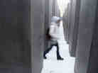 A visitor walks through the Memorial to the Murdered Jews of Europe, also known as the Holocaust Memorial, in Berlin, Germany. A visitor walks through the Memorial to the Murdered Jews of Europe, also known as the Holocaust Memorial, in Berlin, Germany.