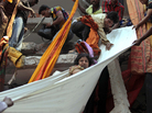 Rescue workers use pieces of clothes to bring down a survivor after an eight-story building housing several garment factories collapsed Wednesday in Savar, near Dhaka, Bangladesh. Rescue workers use pieces of clothes to bring down a survivor after an eight-story building housing several garment factories collapsed Wednesday in Savar, near Dhaka, Bangladesh.
