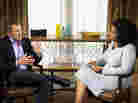 Oprah Winfrey speaks with Lance Armstrong during an interview.