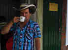 A Colombian farmer sips cofee during a national coffee producers' strike Feb. 25 in Colombia. Thousands of coffee farmers rallied and marched throughout Colombia in protest the economic difficulties of the sector.