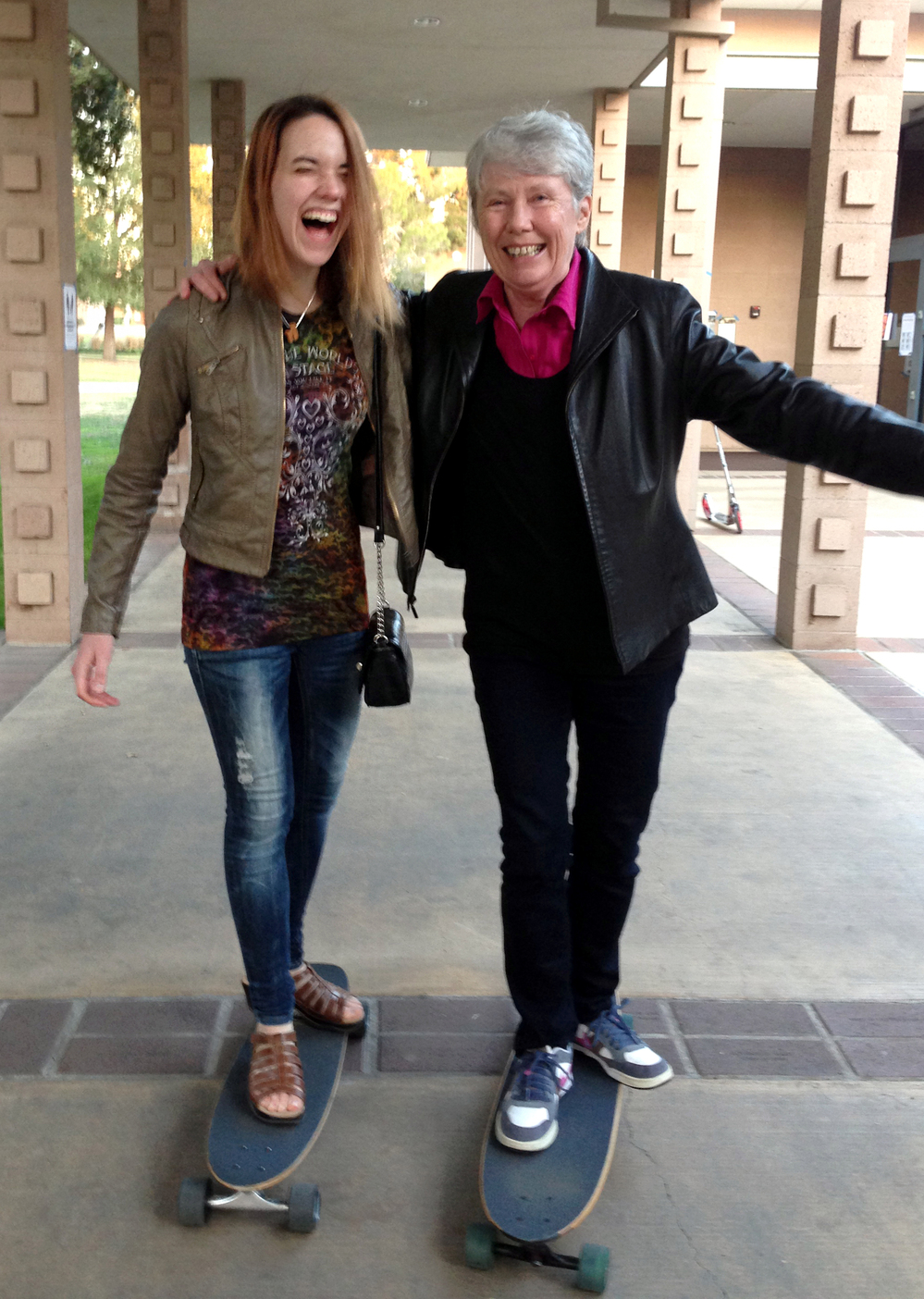 Harvey Mudd President Maria Klawe often uses her longboard to get around campus and chat with students like senior Xanda Schofield.