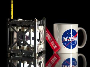The PhoneSats are approximately the size of a coffee cup. The PhoneSats are approximately the size of a coffee cup.