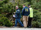 Last week, FBI investigators and a Watertown, Mass., police officer investigate the scene near the boat where bombing suspect Dzhokhar Tsarnaev was hiding. Democrats have argued that the way the government responded to the Boston attacks makes a case for not cutting too deeply.