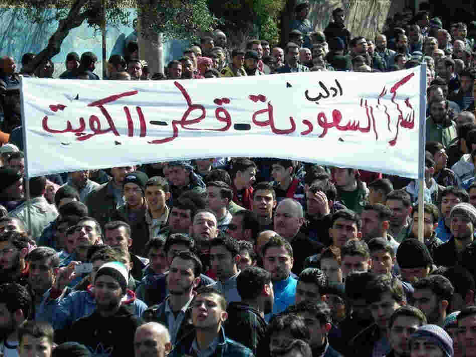 Anti-Syrian regime protesters hold up a banner in Arabic reading, "Thank you Saudi Arabia, Qatar and Kuwait," during a demonstration in Idlib province, northern Syria, in this March 2, 2012, file photo provided by Local Coordination Committees in Syria.