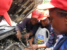 Students at the Lady Mechanic Initiative in Lagos, Nigeria, work on cars in their open air workshop. Students at the Lady Mechanic Initiative in Lagos, Nigeria, work on cars in their open air workshop.