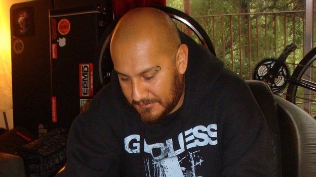Marco Santiago plays a quijada in his home. (Radio Bilingue)