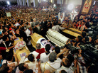 Egyptian Christians gather around four coffins during a funeral service at the Saint Mark Coptic cathedral in Cairo on April 7. Religious violence this month has killed three Muslims and at least six Christians. Egyptian Christians gather around four coffins during a funeral service at the Saint Mark Coptic cathedral in Cairo on April 7. Religious violence this month has killed three Muslims and at least six Christians.