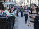 People walk and eat along Boylston Street, near the site of the Boston Marathon bombings, on Wednesday. Businesses in the area have reported strong customer support; they also have an option for federal loans to help them cope with losses.