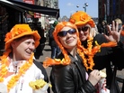 Tourists in Amsterdam wear orange Monday, one day before the investiture of the new Dutch king. Queen Beatrix, who ruled the Netherlands for 33 years, announced her abdication from the throne earlier this year. Tourists in Amsterdam wear orange Monday, one day before the investiture of the new Dutch king. Queen Beatrix, who ruled the Netherlands for 33 years, announced her abdication from the throne earlier this year.