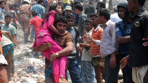 A volunteer carries an injured garment worker after a building collapsed in Savar, on the outskirts of Dhaka, Bangladesh, on April 24, killing hundreds of people.