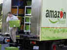 Amazon Fresh delivery man Tim Wilkie totes food to a house on Mercer Island, Wash.