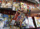 Mary Ann Shilts takes one of the give away comic books from the display rack at the New Dimensions Comics store in Cranberry, Pa., Butler County, as part of Free Comic Book Day 2012. Free Comic Book Day 2013 is Saturday, May 4.