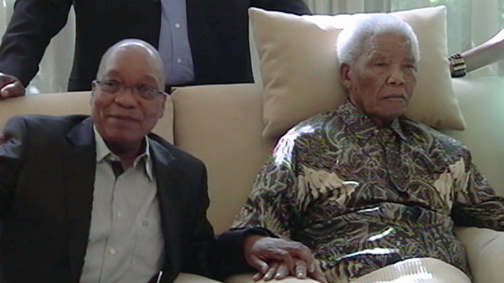 In this image taken from video, South African President Jacob Zuma sits with ailing anti-apartheid icon Nelson Mandela on Monday. Mandela was hospitalized in late March with a lung infection, and in images from the visit, appeared largely unresponsive.