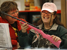 A woman holds a .22-caliber Crickett youth rifle at a Gander Mountain store in Flint Township, Mich. This type of gun, which is marketed to children and comes in a variety of colors, was involved in the shooting death of a 2-year-old girl in Kentucky. A woman holds a .22-caliber Crickett youth rifle at a Gander Mountain store in Flint Township, Mich. This type of gun, which is marketed to children and comes in a variety of colors, was involved in the shooting death of a 2-year-old girl in Kentucky.